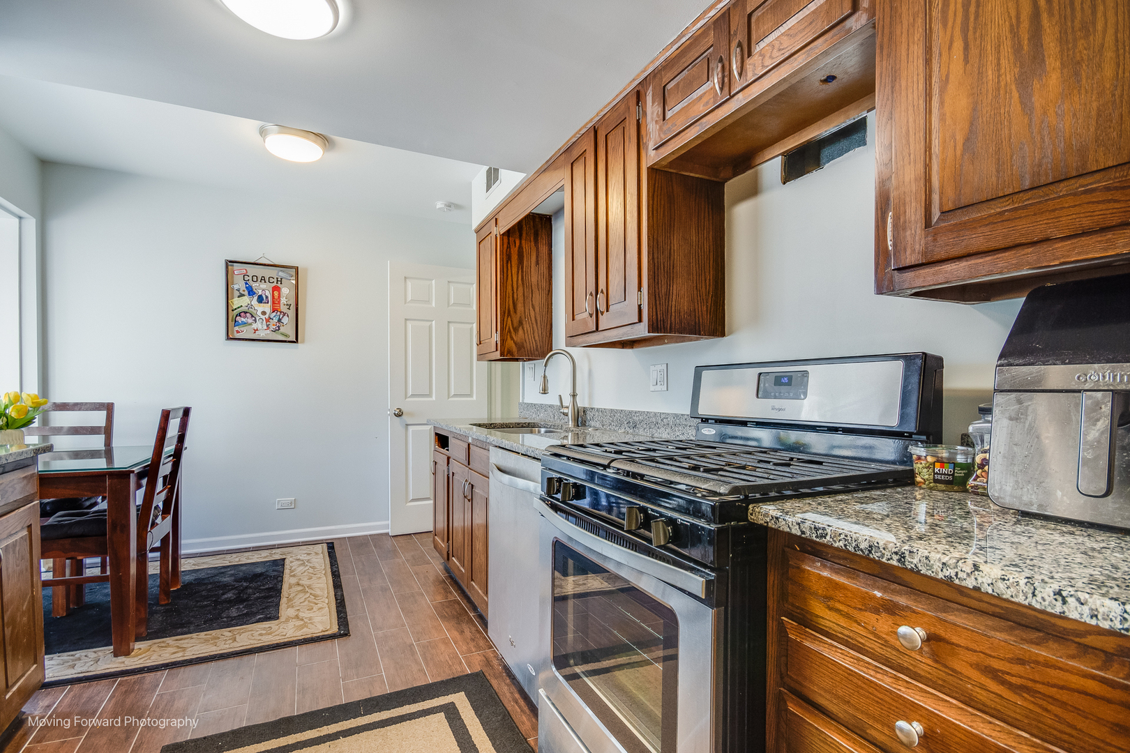 133 Rivershire Lane Lincolnshire, IL 60069 - Photo 10 of 26 a kitchen with stainless steel appliances granite countertop a stove a sink and a microwave