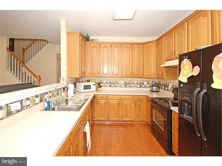3 Sandstone Road East Windsor, NJ 08520 - Photo 11 of 24 a kitchen with a sink stove and cabinets