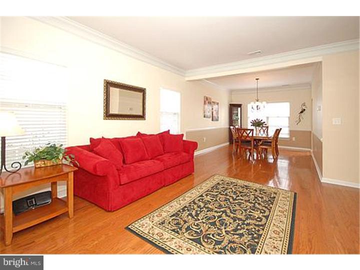 3 Sandstone Road East Windsor, NJ 08520 - Photo 13 of 24 a living room with furniture a rug and a dining table with wooden floor