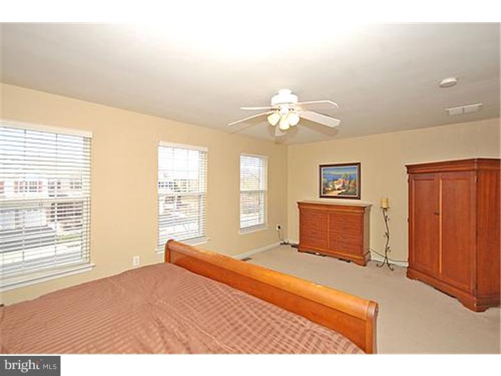 3 Sandstone Road East Windsor, NJ 08520 - Photo 15 of 24 a bedroom with a bed and a chandelier