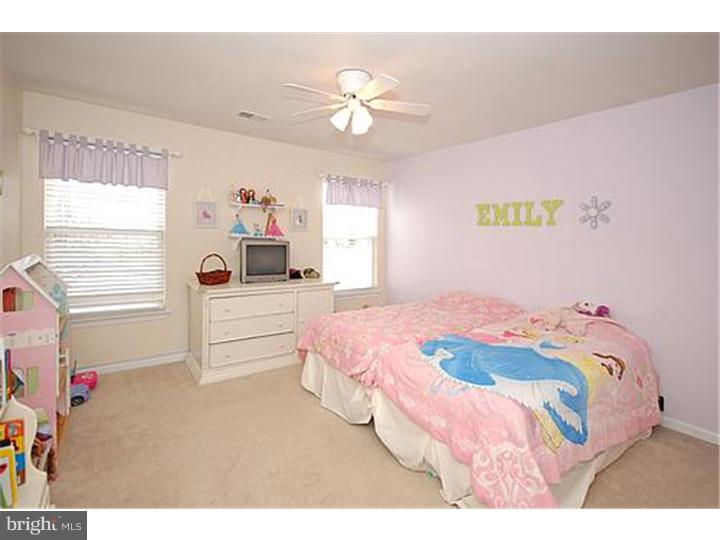 3 Sandstone Road East Windsor, NJ 08520 - Photo 22 of 24 a bedroom with a bed and a chandelier