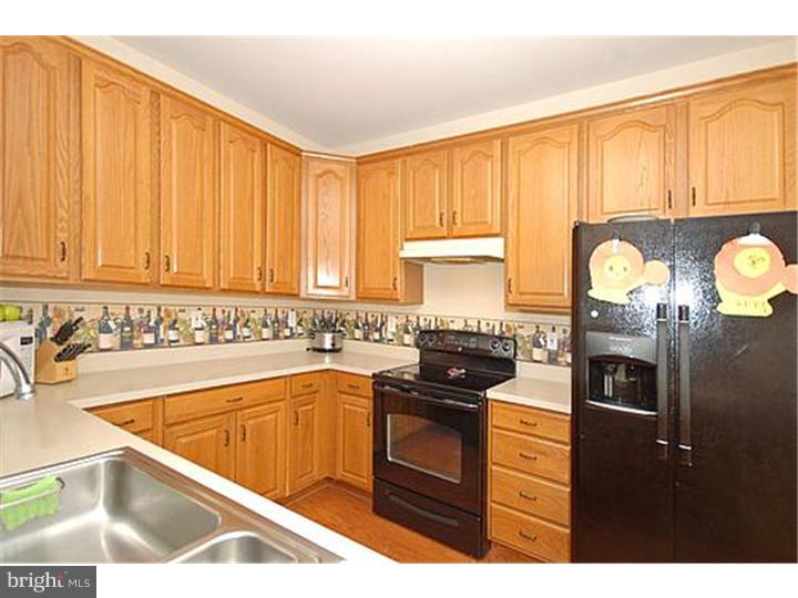3 Sandstone Road East Windsor, NJ 08520 - Photo 9 of 24 a kitchen with stainless steel appliances granite countertop a stove a sink and a microwave