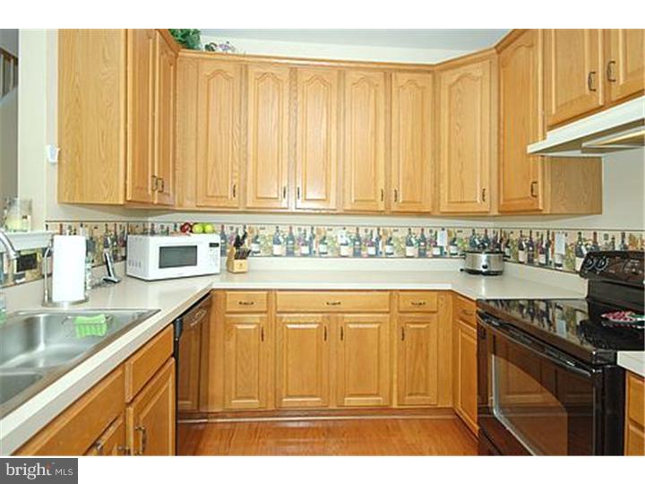 3 Sandstone Road East Windsor, NJ 08520 - Photo 10 of 24 a kitchen with stainless steel appliances granite countertop a refrigerator a sink dishwasher and wooden cabinets