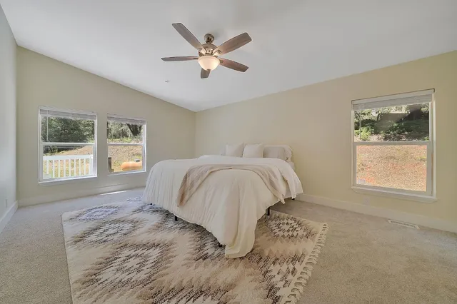 a spacious bedroom with a bed and a window