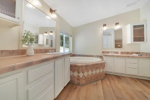 a bathroom with a granite countertop sink mirror and toilet