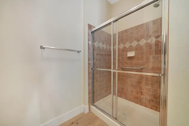 a bathroom with a glass shower door