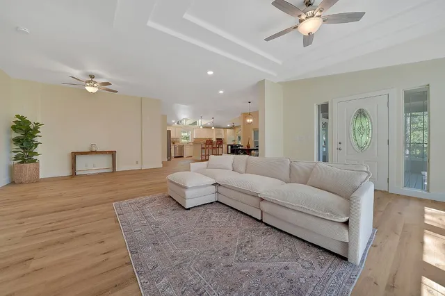 a living room with furniture and a chandelier