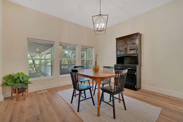 a view of a dining room with furniture window and wooden floor