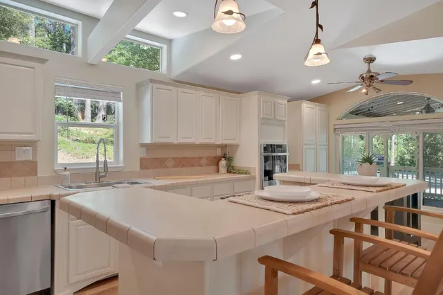 a kitchen with a stove a sink and a refrigerator