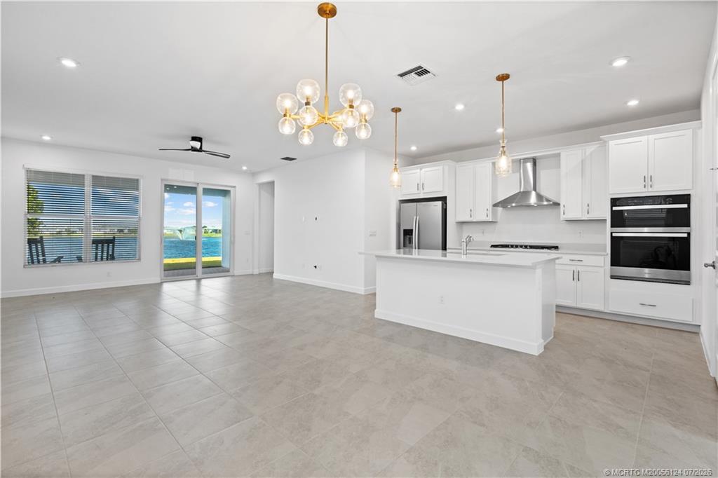 9731 Southwest Indra Way Port St. Lucie, FL 34987 - Photo 5 of 33 Kitchen/ Living/ Dining