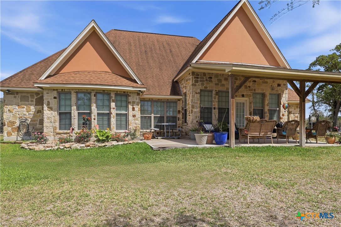 790 Spanish Grant Road Goliad, TX 77963 - Photo 33 of 41 a view of a house with sitting area and garden