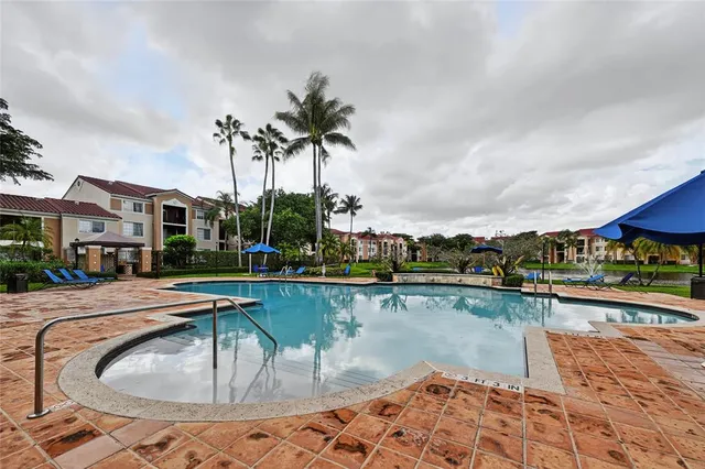 a swimming pool with outdoor seating and lake view
