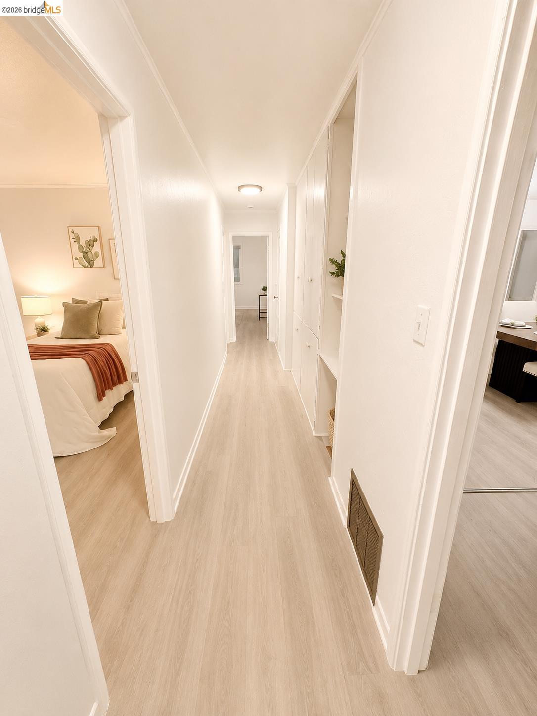 810 Pierce Street Albany, CA 94706 - Photo 11 of 25 Hallway featuring wood-finish flooring, white walls, and built-in storage cabinetry with open shelving