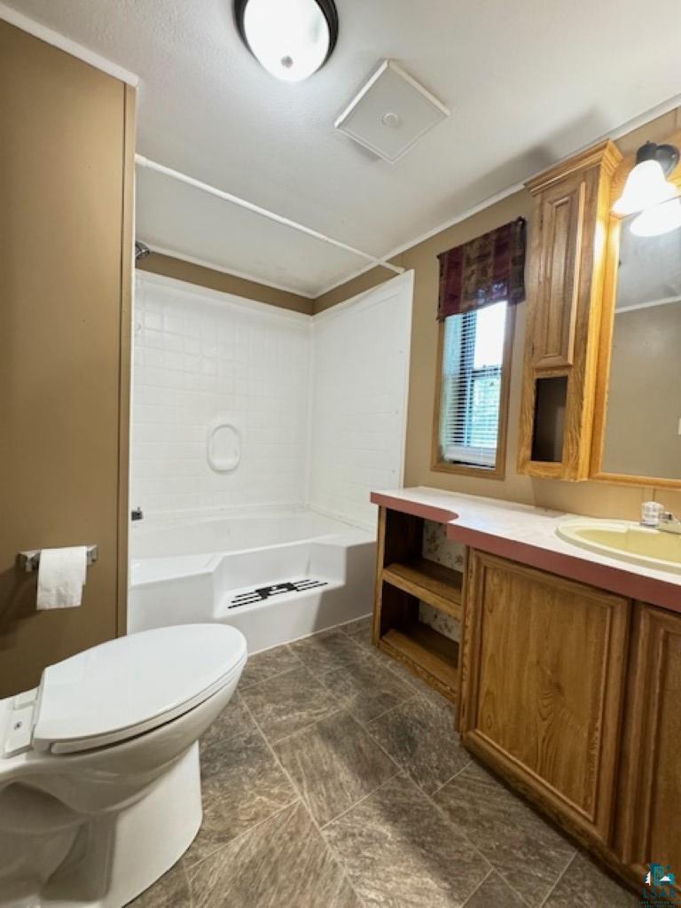 12 West St Louis River Road Esko, MN 55733 - Photo 13 of 20 Full bathroom with tile flooring, vanity, toilet, and bathing tub / shower combination