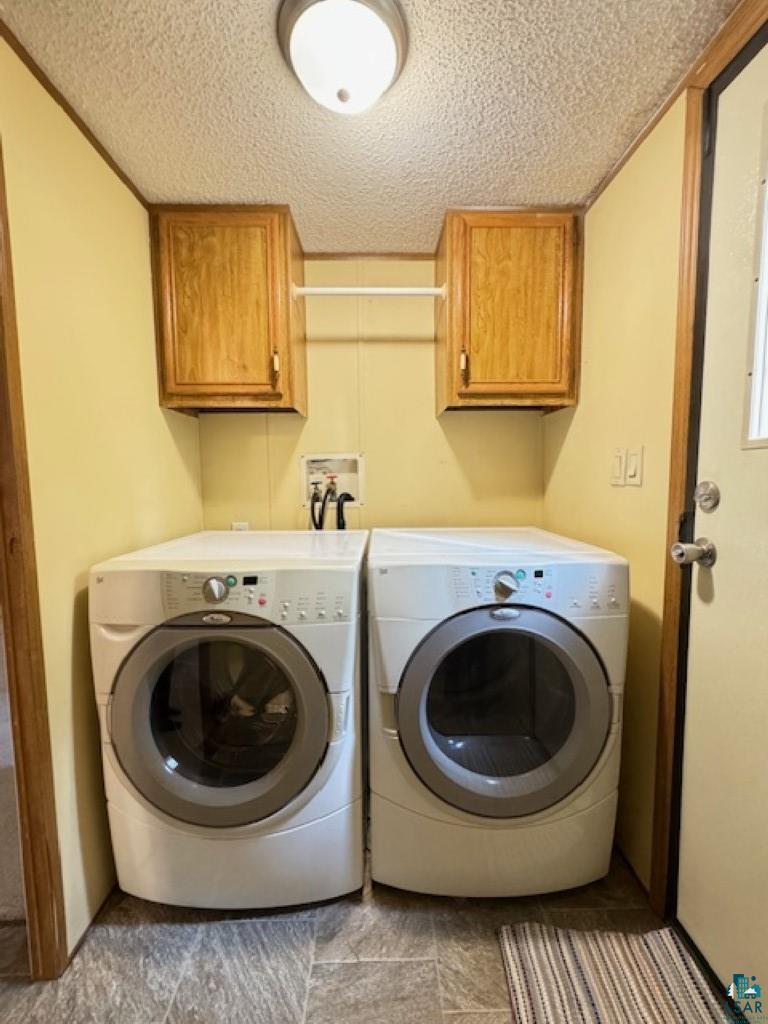 12 West St Louis River Road Esko, MN 55733 - Photo 18 of 20 Washroom featuring cabinets, washer hookup, a textured ceiling, and washing machine and clothes dryer