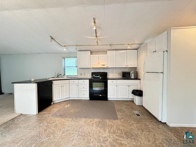 12 West St Louis River Road Esko, MN 55733 - Photo 7 of 20 Kitchen with white fridge, dishwasher, electric range, rail lighting, and sink