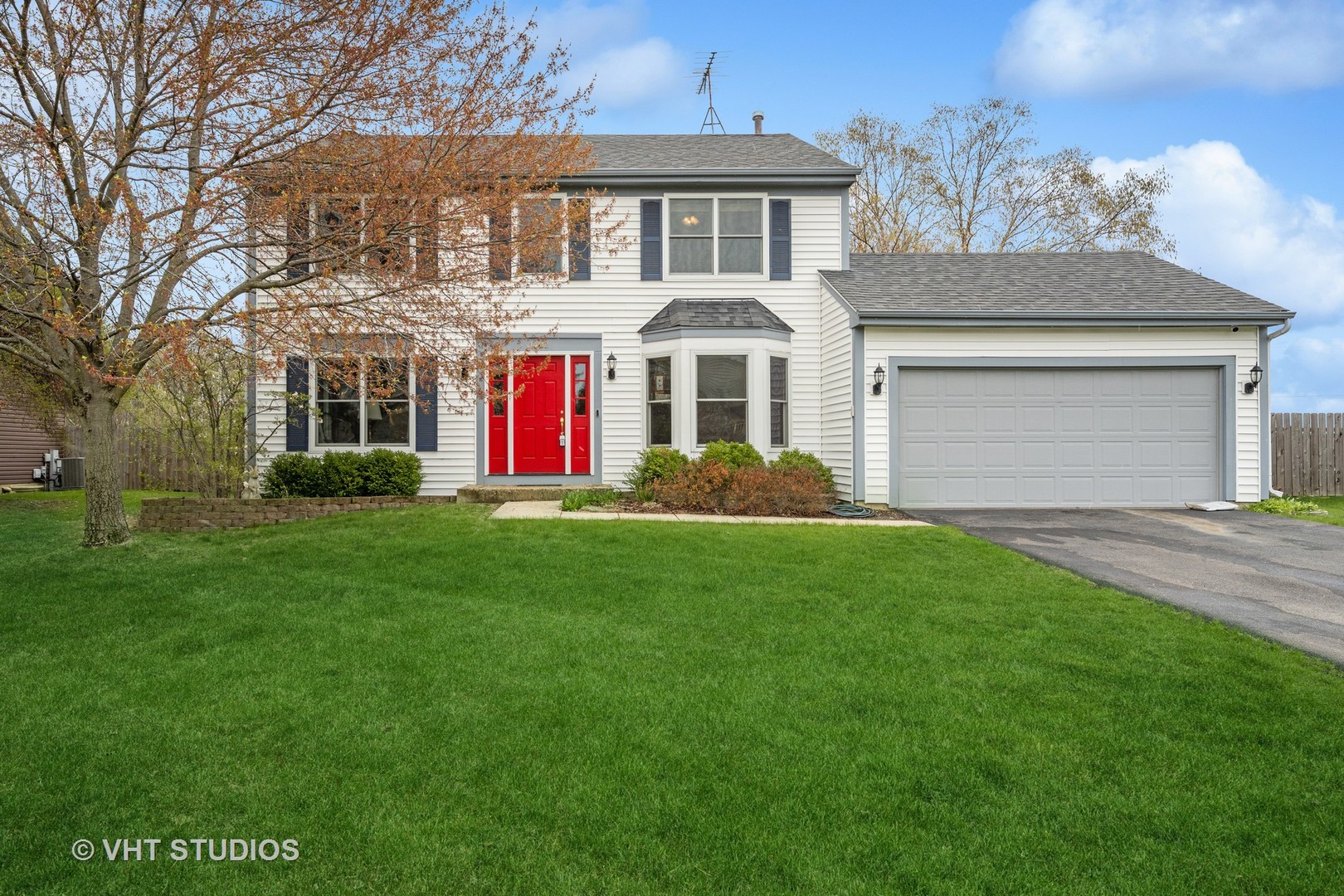 a front view of house with yard and green space