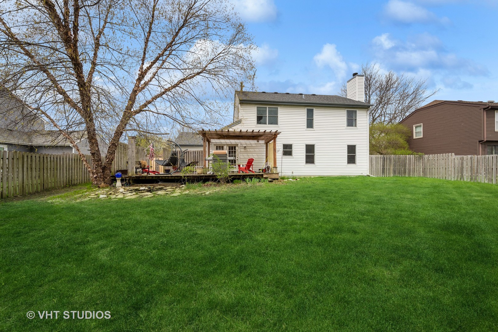 1402 Cherry Drive Batavia, IL 60510 - Photo 17 of 22 a view of a white house with a big yard and large trees