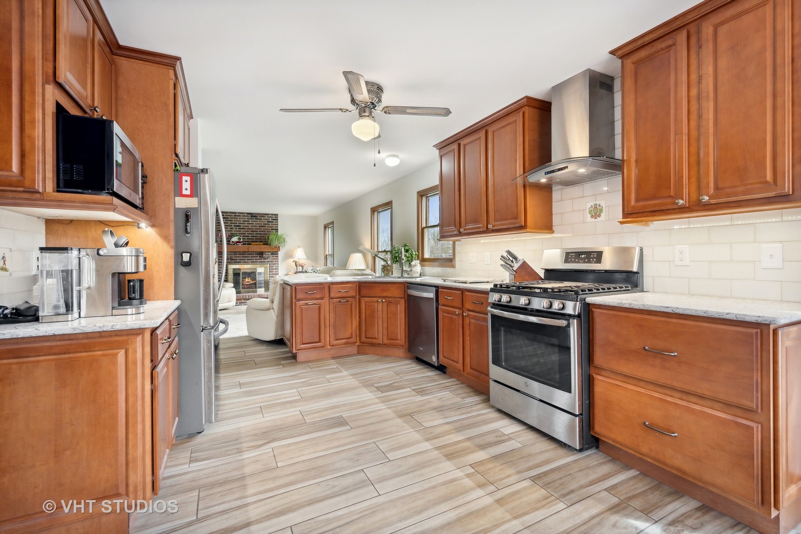 1402 Cherry Drive Batavia, IL 60510 - Photo 6 of 22 a kitchen with stainless steel appliances granite countertop a stove cabinets and entryway