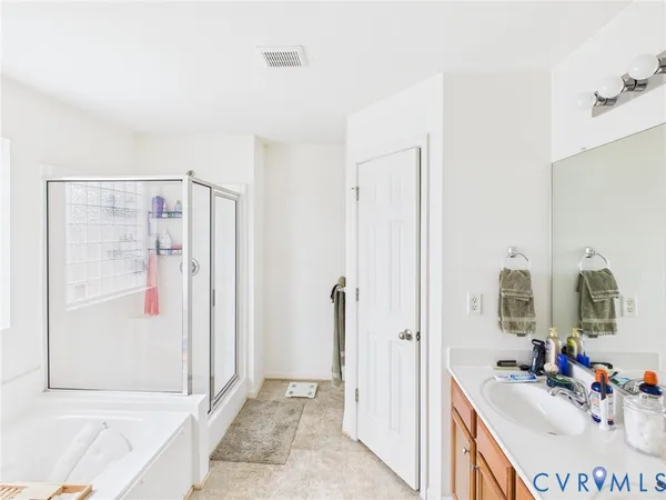 a view of a bathroom with a tub shower and mirror