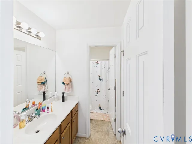 a bathroom with a sink vanity and a mirror