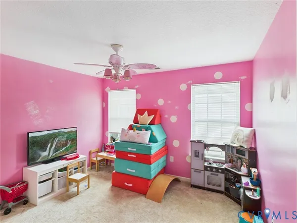 a bedroom with furniture and a flat screen tv