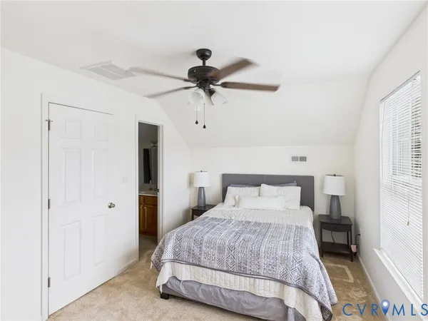 a bedroom with a bed and a ceiling fan