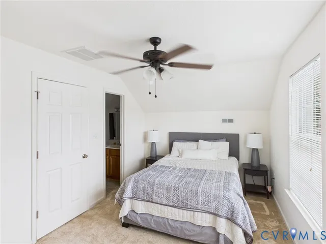 a bedroom with a bed and a ceiling fan