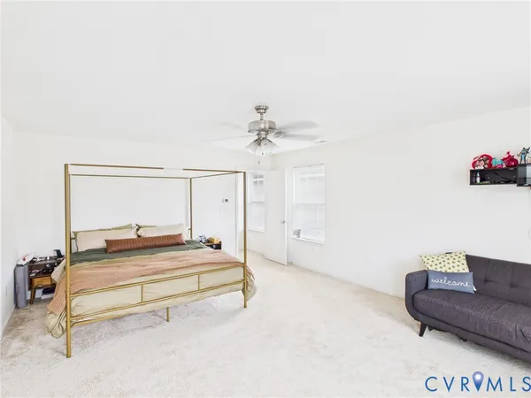 a spacious bedroom with a bed and a couch