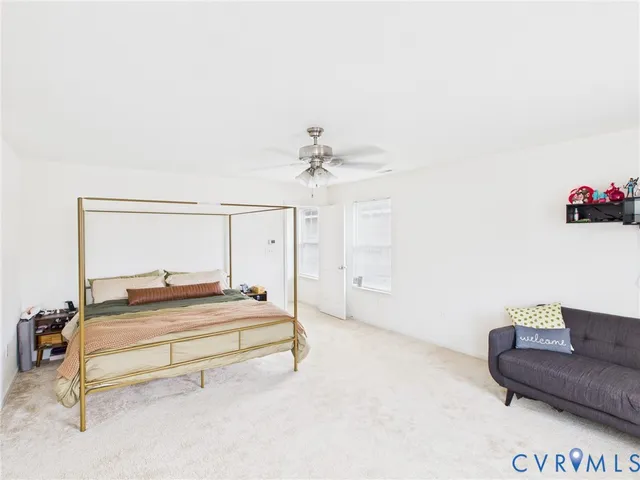 a spacious bedroom with a bed and a couch