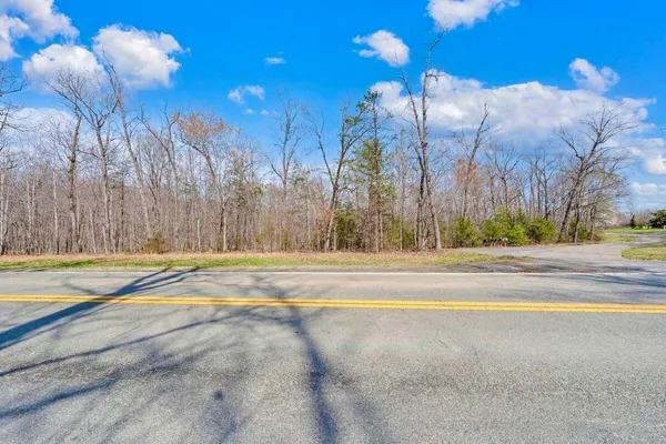 a view of a house with swimming pool and a yard