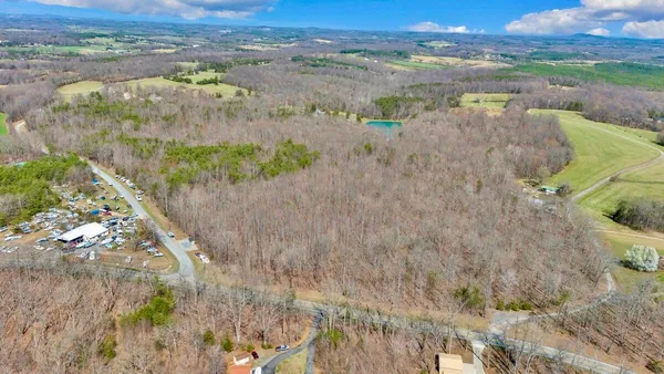 a view of a yard with wooden fence