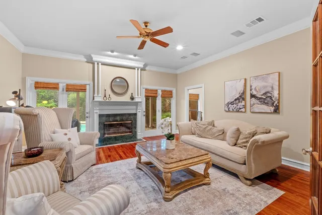 a living room with furniture a clock and a fireplace