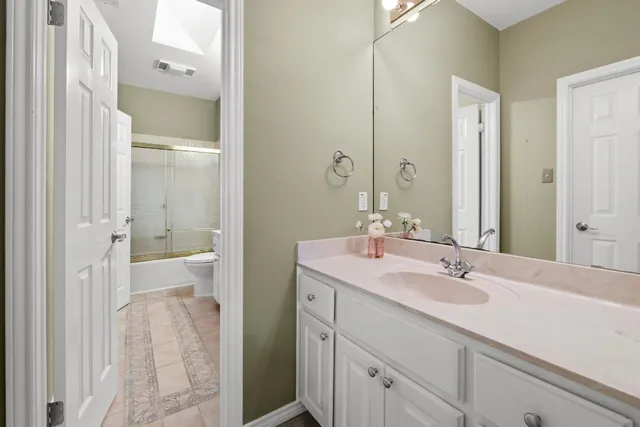 a bathroom with a sink a mirror and a shower