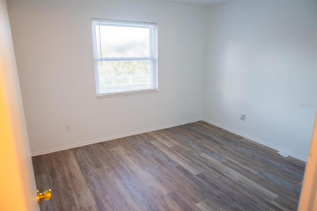 1902 Honour Road, Unit 23 Orlando, FL 32839 - Photo 20 of 31 an empty room with wooden floor and windows