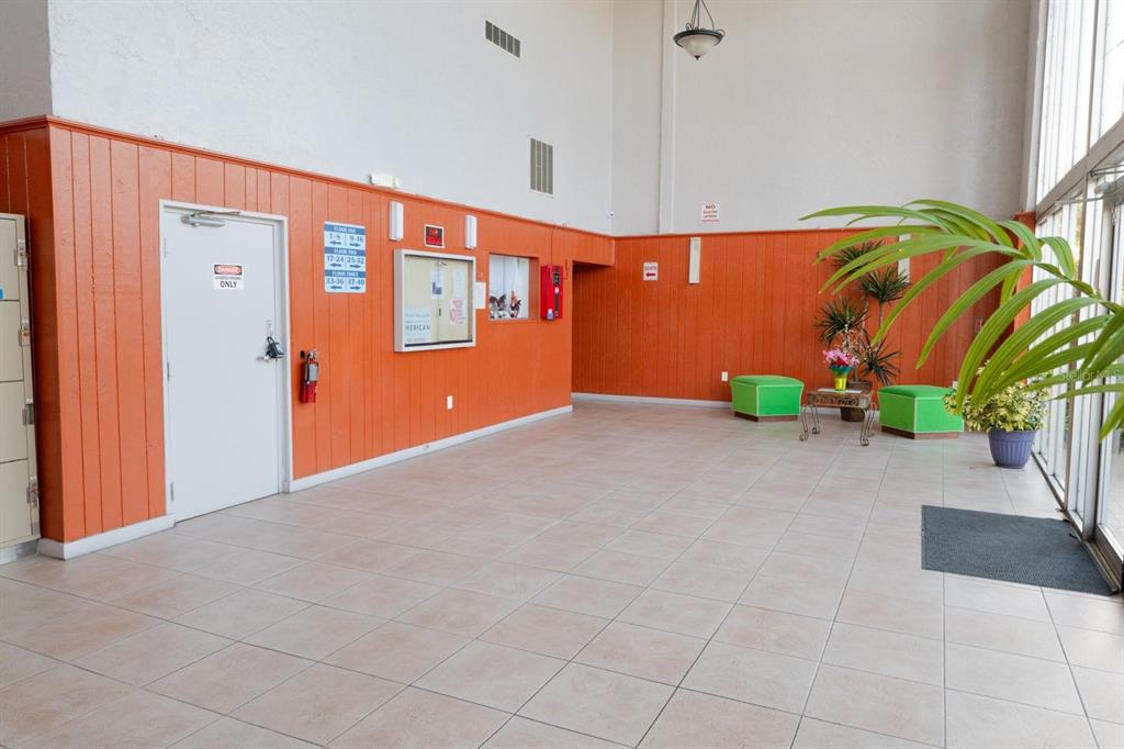 1902 Honour Road, Unit 23 Orlando, FL 32839 - Photo 5 of 31 an empty room with windows and potted plants