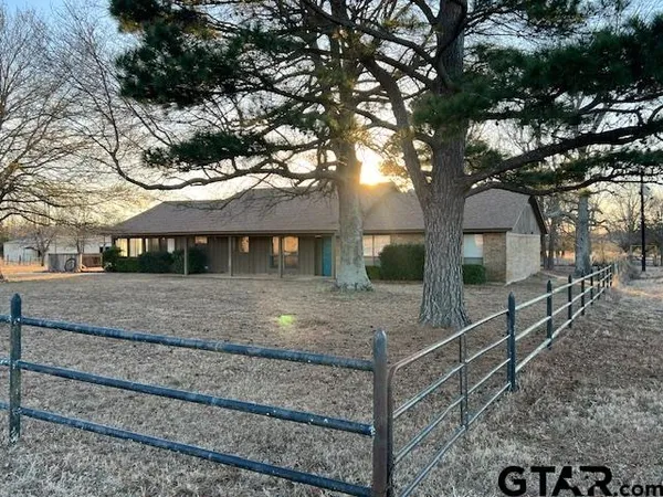 a view of a house with large tree