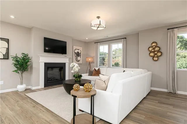 a living room with furniture fireplace and window