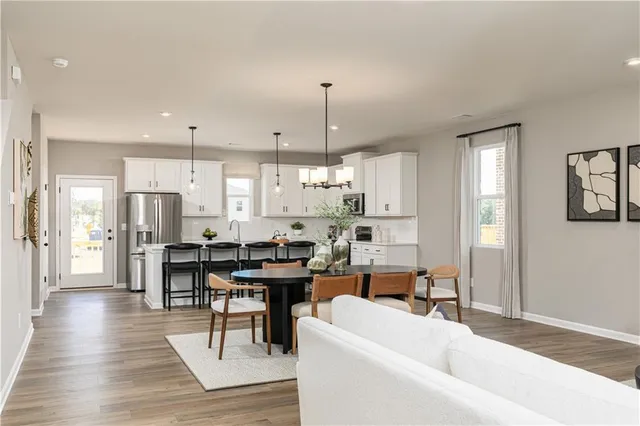 a view of a dining room with furniture window and wooden floor