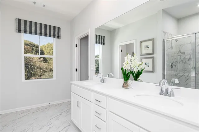 a bathroom with a double vanity sink and a mirror