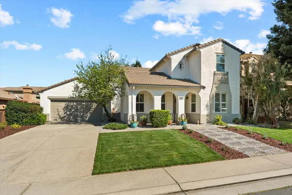 a front view of a house with a yard