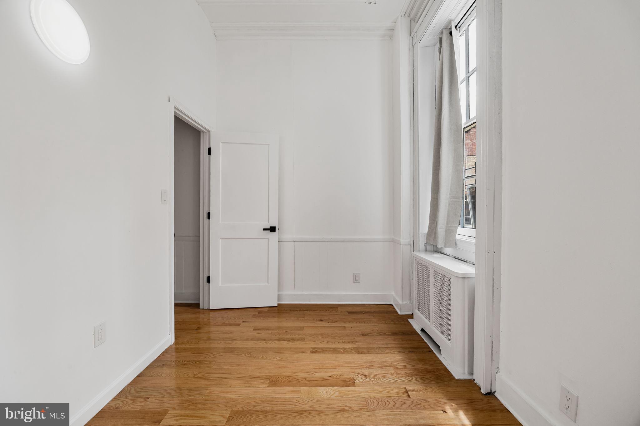 1225 Spruce Street, Unit 1F Philadelphia, PA 19107 - Photo 14 of 21 a view of an empty room with wooden floor