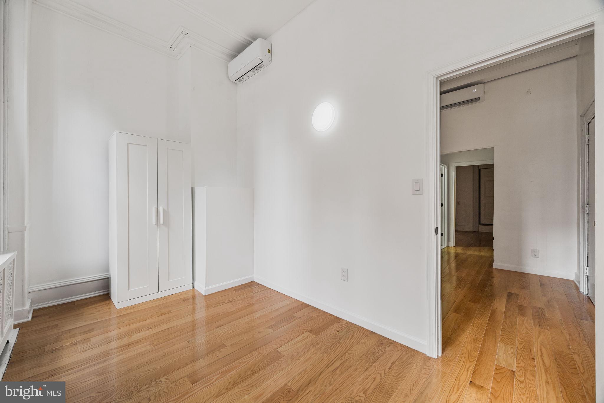 1225 Spruce Street, Unit 1F Philadelphia, PA 19107 - Photo 15 of 21 a view of a hallway with wooden floor