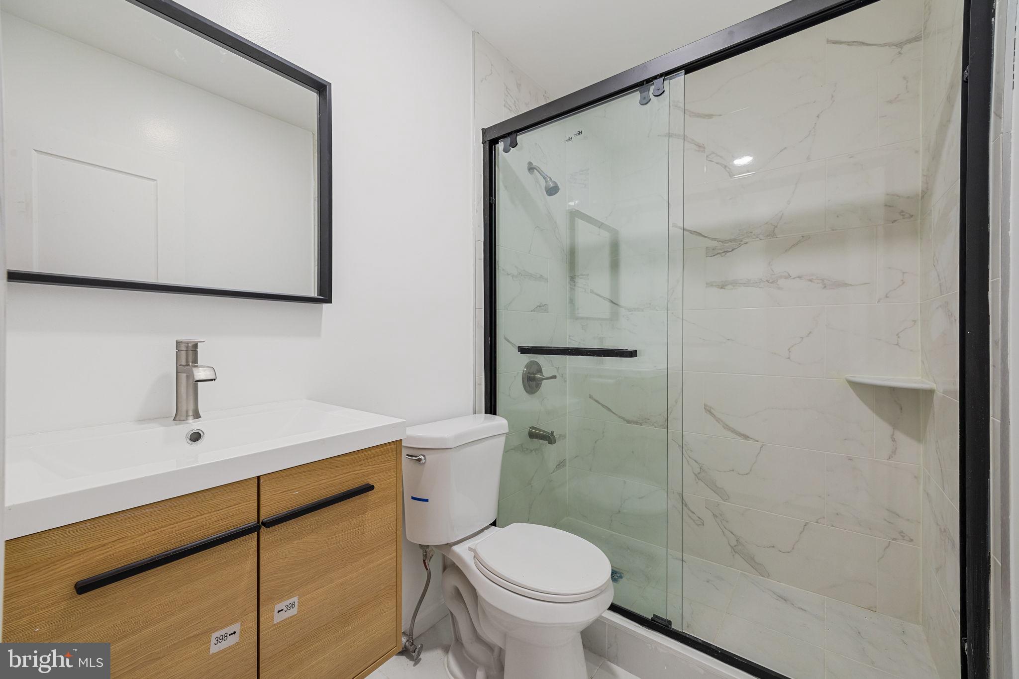 1225 Spruce Street, Unit 1F Philadelphia, PA 19107 - Photo 16 of 21 a bathroom with a sink a toilet and shower