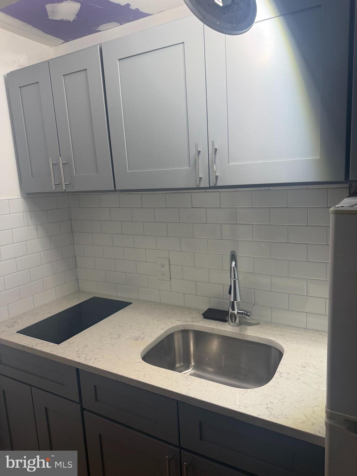 1225 Spruce Street, Unit 1F Philadelphia, PA 19107 - Photo 7 of 21 a kitchen with a sink and cabinets