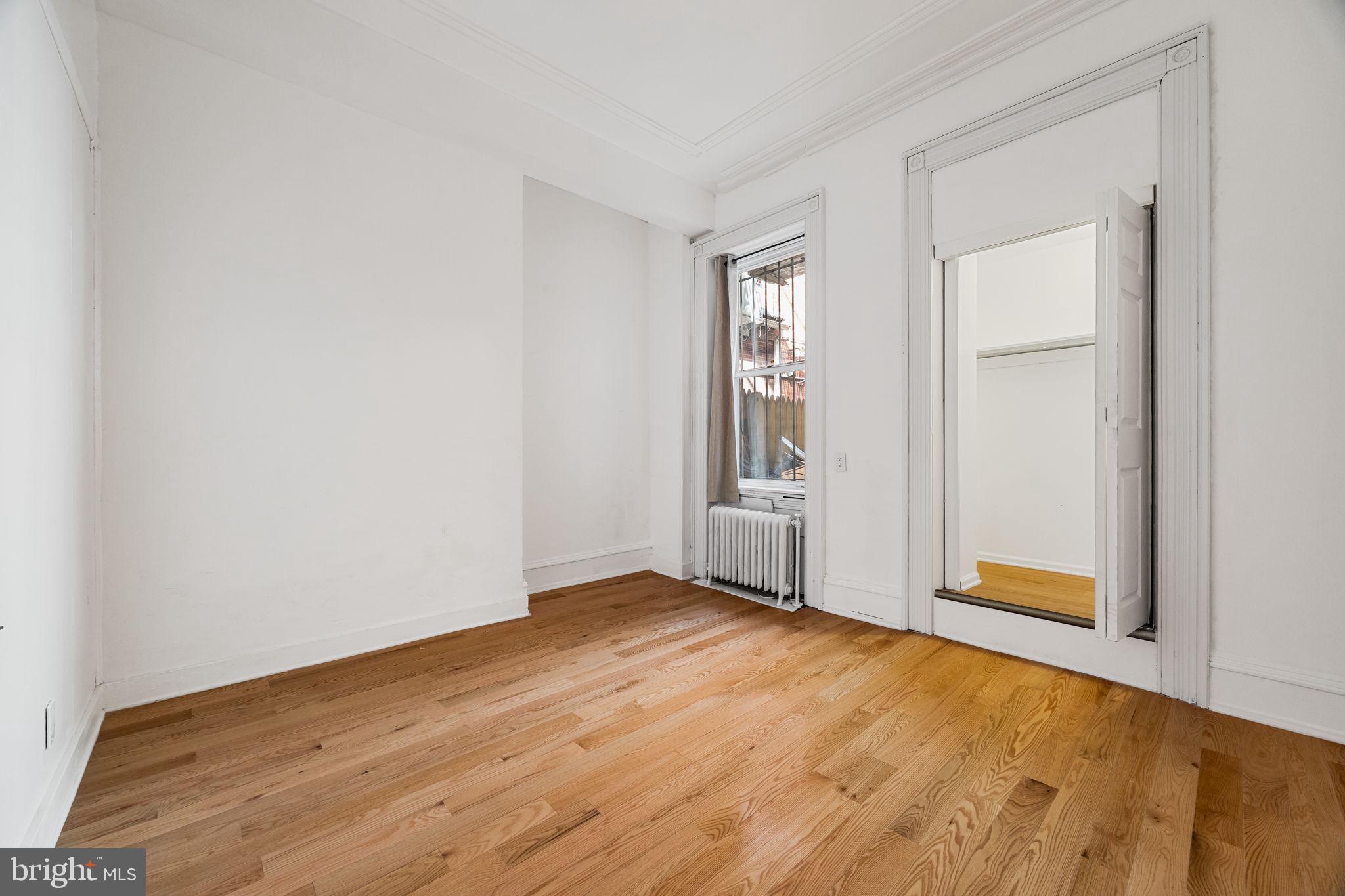 1225 Spruce Street, Unit 1F Philadelphia, PA 19107 - Photo 9 of 21 an empty room with closet and windows