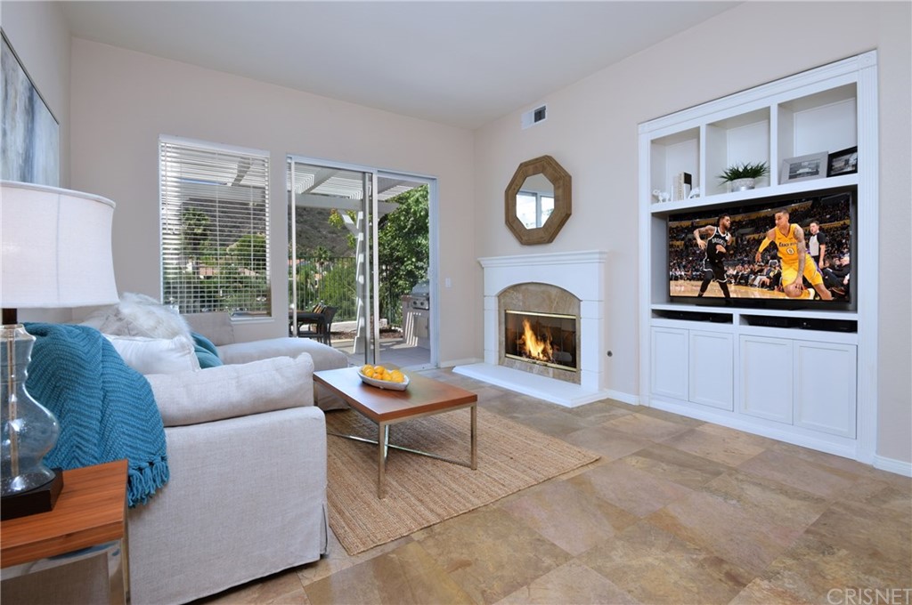3619 Cll Joaquin Calabasas, CA 91302 - Photo 12 of 42 a living room with furniture a large window and a fireplace