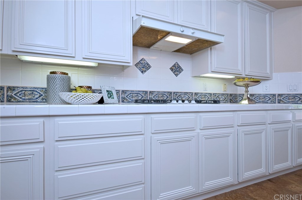 3619 Cll Joaquin Calabasas, CA 91302 - Photo 26 of 42 a kitchen with white cabinets and a sink