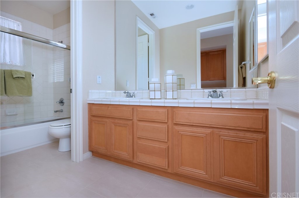 3619 Cll Joaquin Calabasas, CA 91302 - Photo 30 of 42 a bathroom with a granite countertop sink mirror vanity and toilet