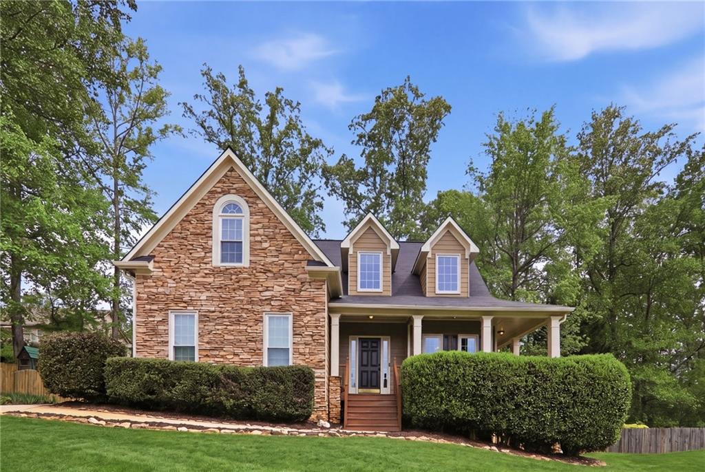 a front view of a house with a yard garage and outdoor seating